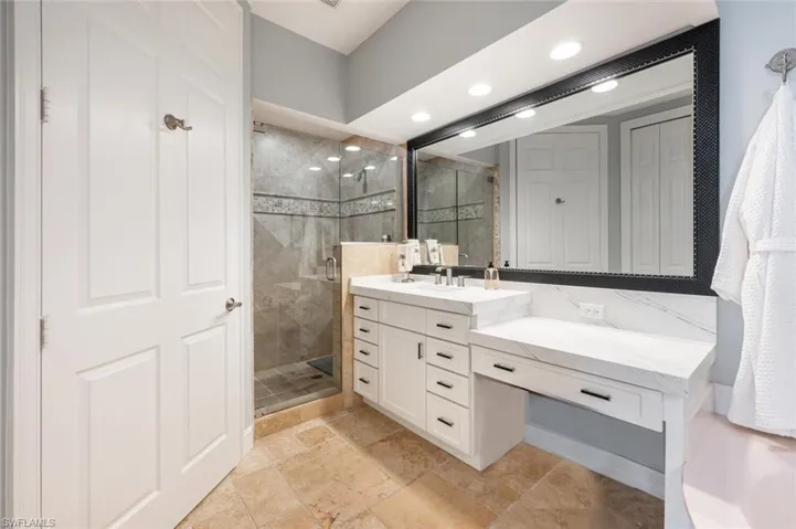 Walk in tile shower, separate water closet, and linen closet