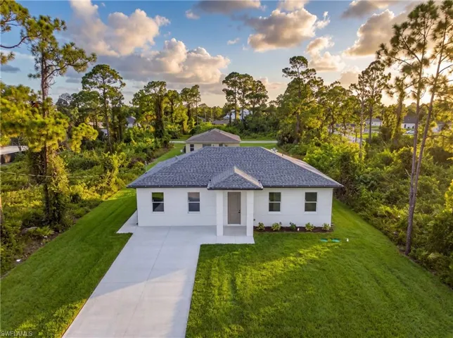 Contemporary single-story residence with a gray shingle roof, white exterior siding, and a concrete driveway