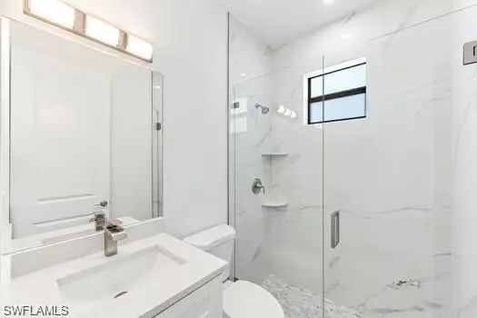 2nd Bathroom in Second Unit with a marble finish shower and vanity