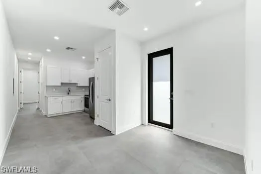 Living room in Second Unit  featuring recessed lighting and concrete floors