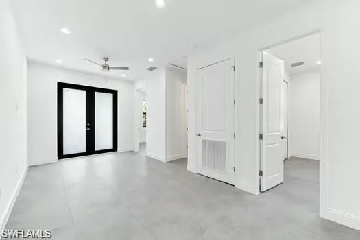 With recessed lighting, concrete flooring, and a ceiling fan