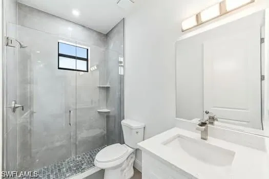 Full bath with vanity and a shower stall on main entrance side