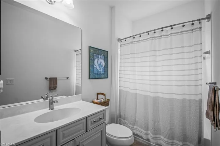 Bathroom with vanity and shower / bath combination with curtain