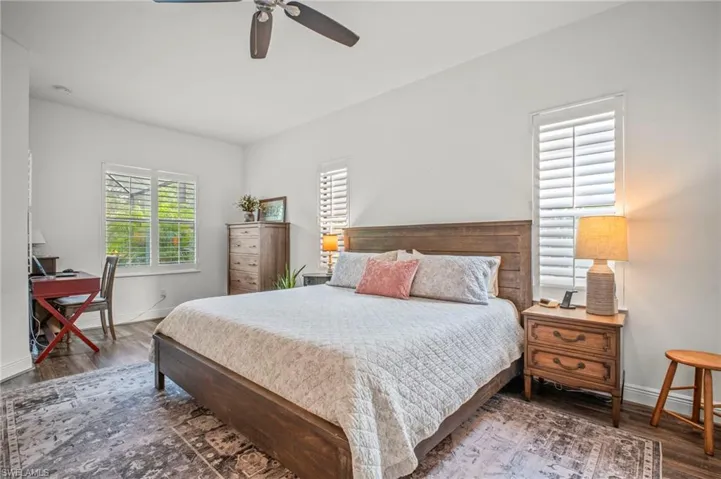 Bedroom featuring dark wood-style flooring and ceiling fan