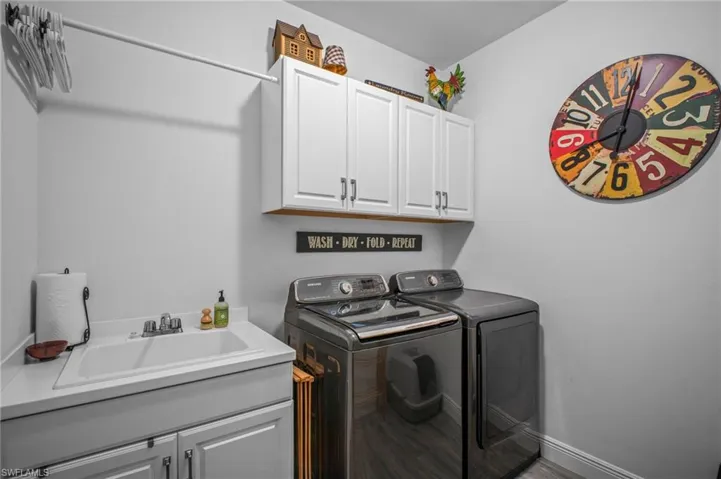 Laundry room with cabinet space and washing machine and dryer