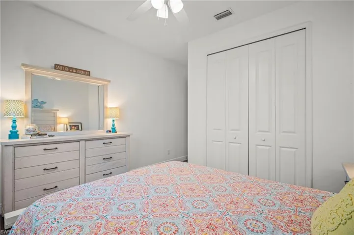 Bedroom with a ceiling fan and a closet