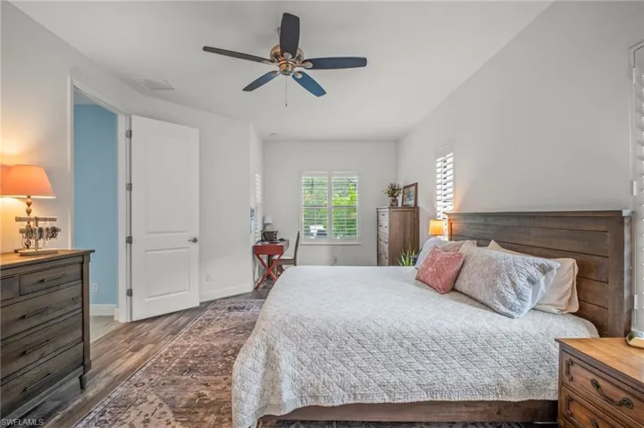 Bedroom featuring dark wood-style floors and a ceiling fan