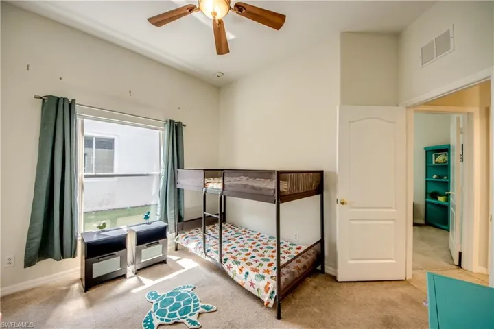 Recessed lighting, ceiling fan, carpet flooring, and a window with blinds