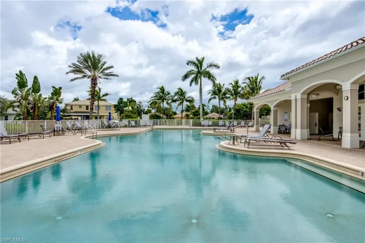 Expansive outdoor swimming pool with a surrounding paved deck
