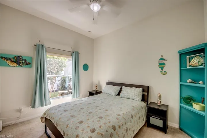 Recessed lighting, ceiling fan, window with exterior landscaping, light-toned carpeting, and light-toned walls