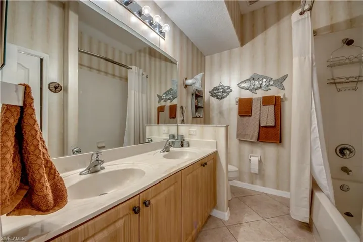 Dual basin vanity with light wood-finish cabinetry