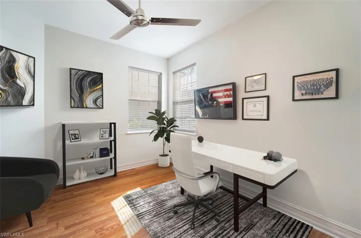 Home office featuring ceiling fan and light wood-type flooring