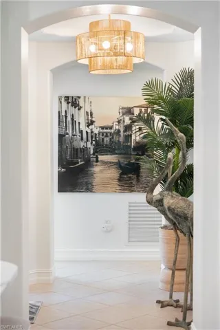 Bar with a notable chandelier and tile patterned flooring