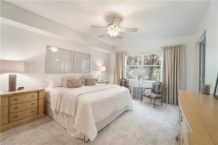 Bedroom featuring ceiling fan and light colored carpet