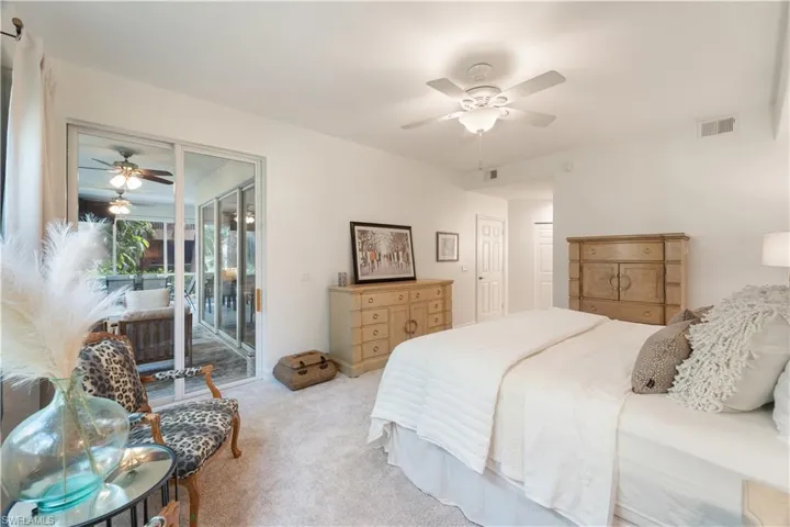 Bedroom with light carpet, access to exterior, and ceiling fan