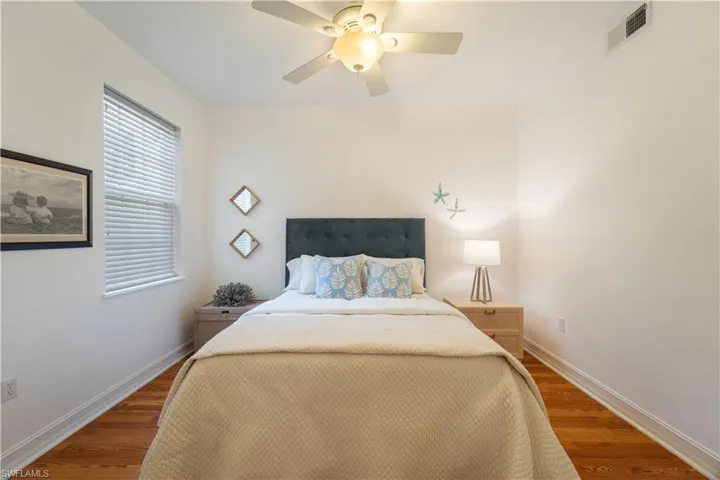 Bedroom featuring ceiling fan and hardwood / wood-style floors