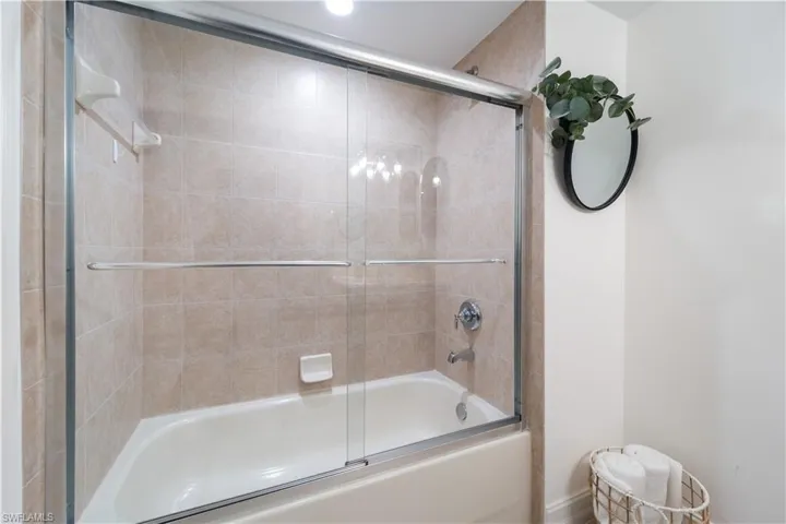 Bathroom featuring enclosed tub / shower combo
