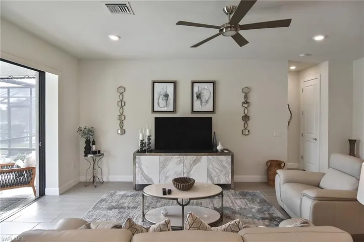 Living area with recessed lighting, ceiling fan, and wood finished floors