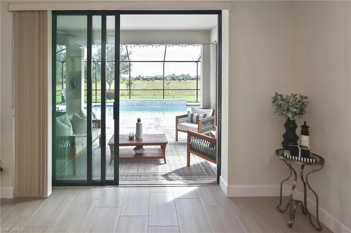 Doorway to outside with baseboards and wood finish floors