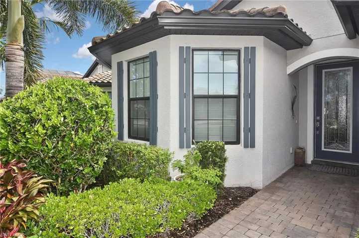 Entrance to property featuring a tiled roof and stucco siding