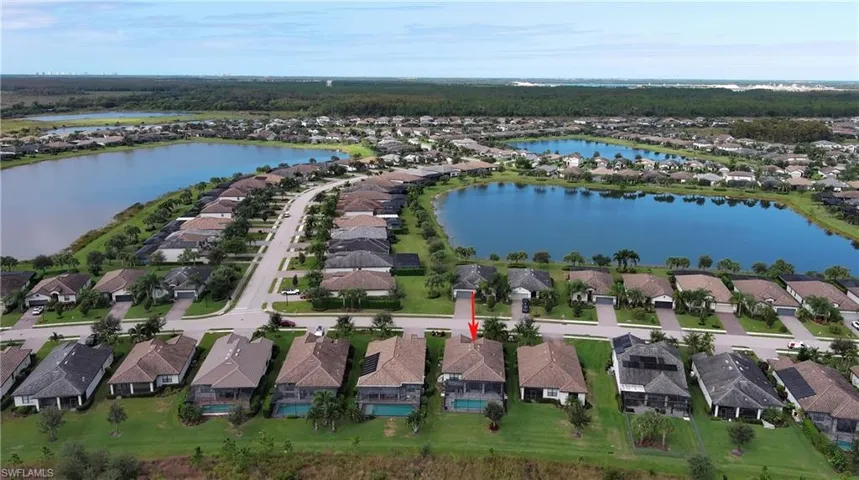 Aerial view of property's location featuring nearby suburban area and a nearby body of water