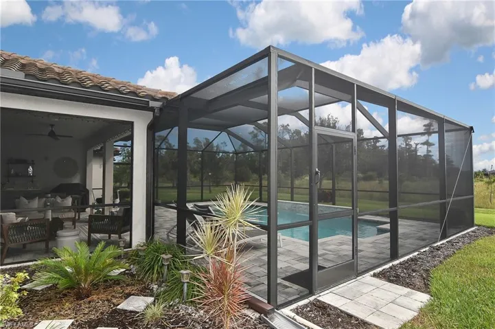 Outdoor pool featuring a patio, ceiling fan, a lanai, and a sunroom