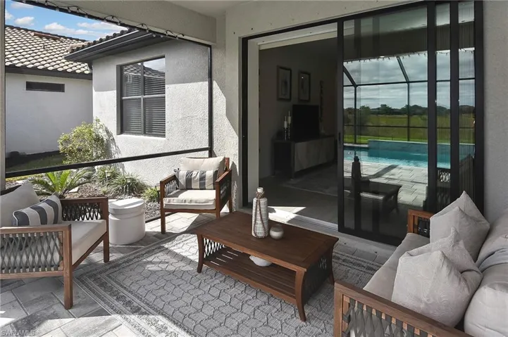 Balcony featuring a sunroom and outdoor lounge area