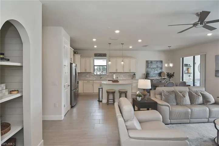 Living area featuring recessed lighting, a ceiling fan, and light wood-style flooring