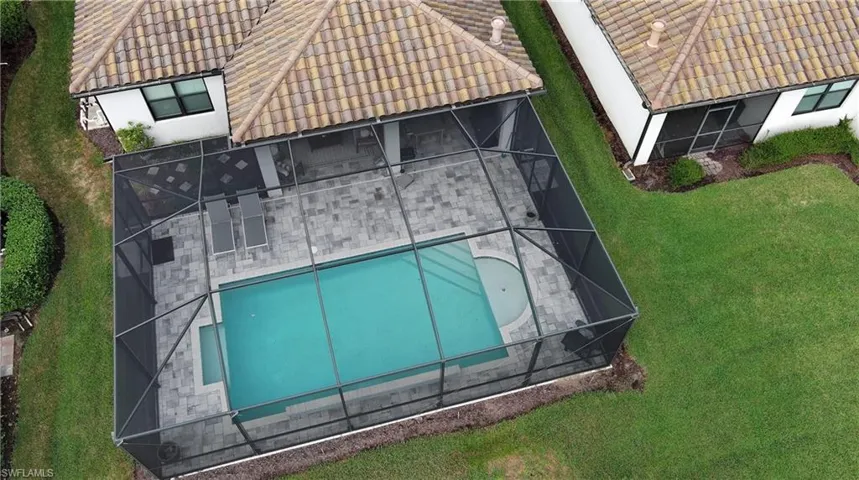 Aerial view of property and surrounding area with a pool area