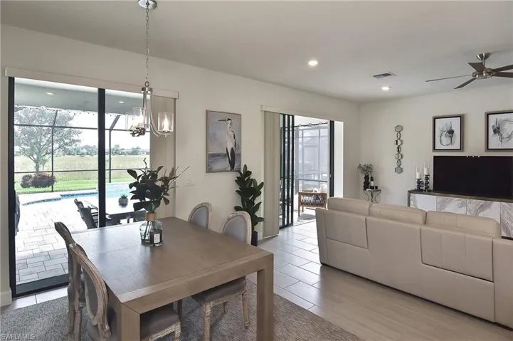 Dining room featuring ceiling fan, a chandelier, recessed lighting, and light wood-style floors