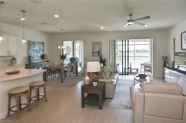 Living area with recessed lighting, light wood-type flooring, and a ceiling fan