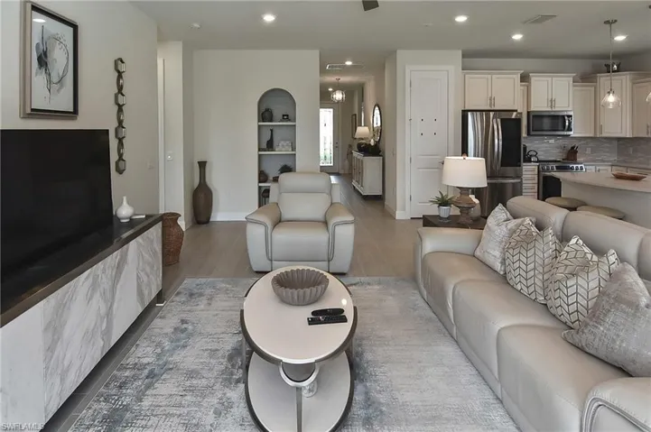 Living area featuring light wood-style floors and recessed lighting