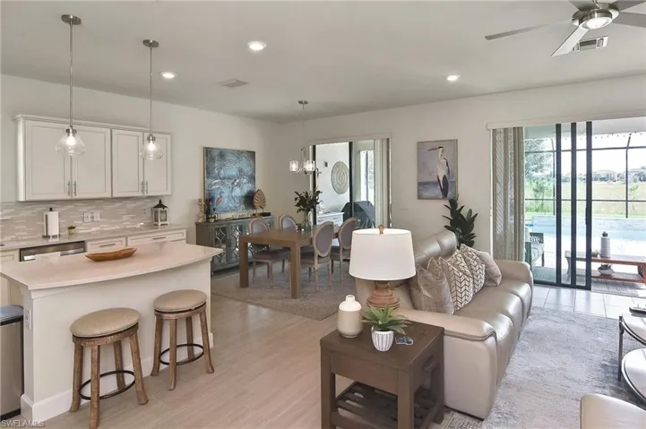 Living area featuring recessed lighting, ceiling fan, and a chandelier