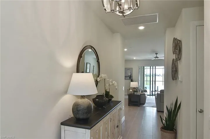 Hallway with recessed lighting and light tile patterned floors