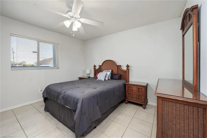 Primary bedroom featuring ceiling fan and tile floors