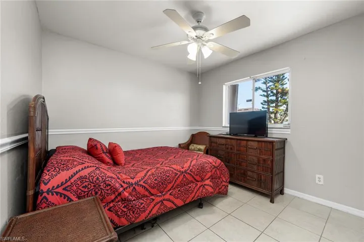Bedroom featuring tile floors and ceiling fan