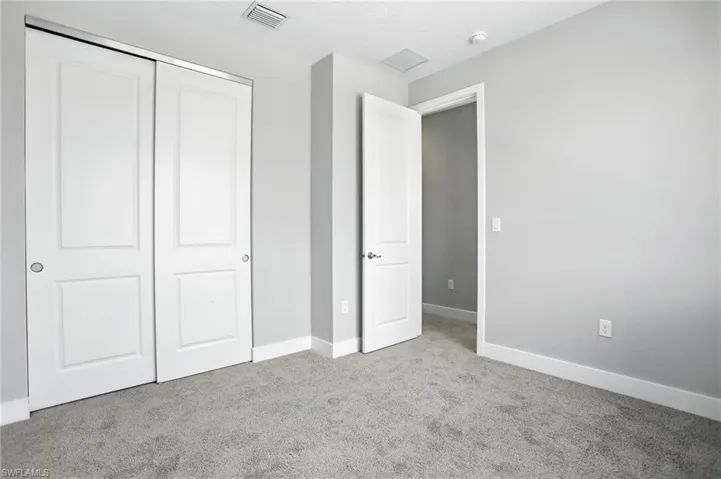 Unfurnished bedroom featuring carpet flooring, a closet, and a textured ceiling