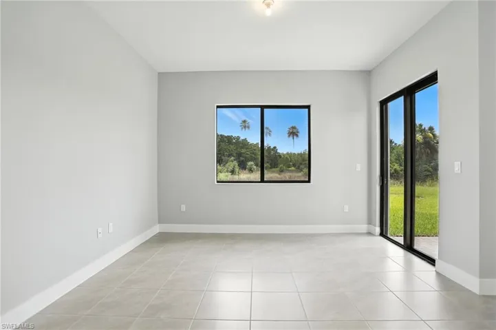 Empty room featuring light tile patterned floors