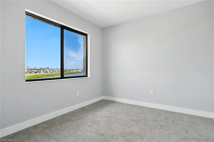 Spare room featuring carpet flooring and a water view