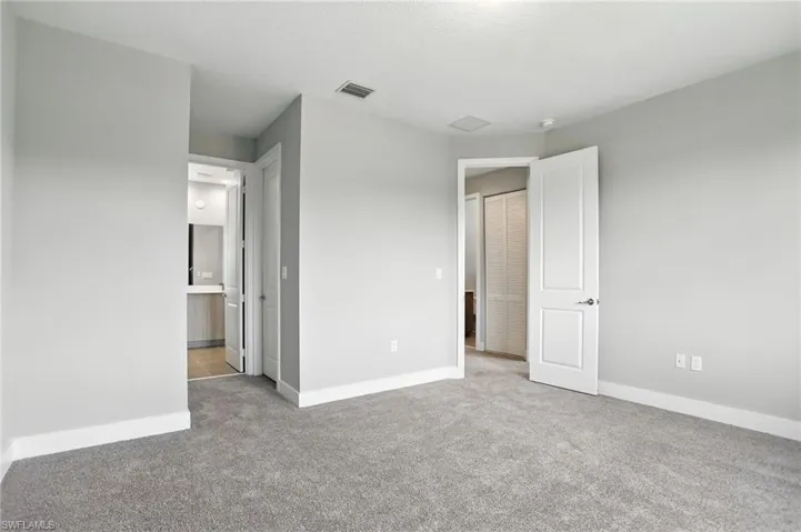 Unfurnished bedroom with baseboards and carpet