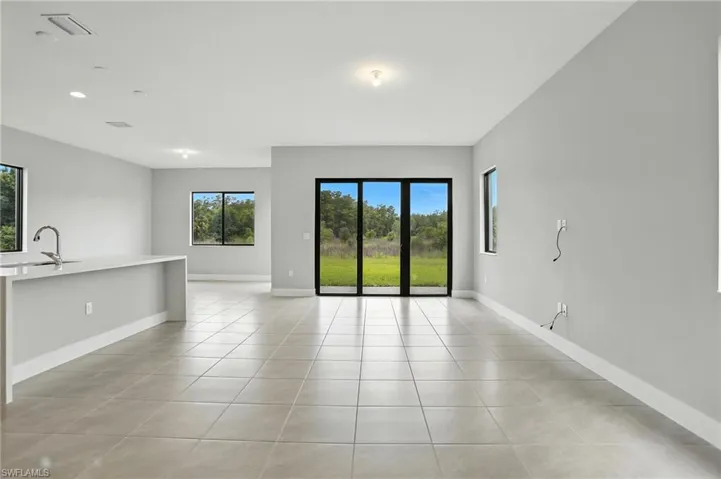 Unfurnished living room with light tile patterned floors