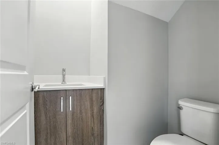 Half bath with vanity and a textured ceiling