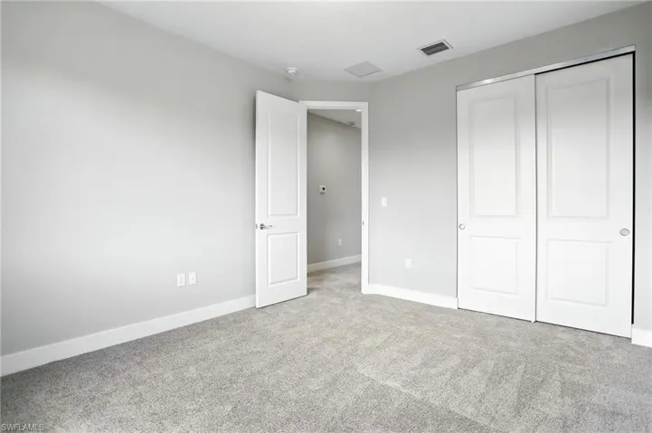 Unfurnished bedroom with carpet floors and a closet