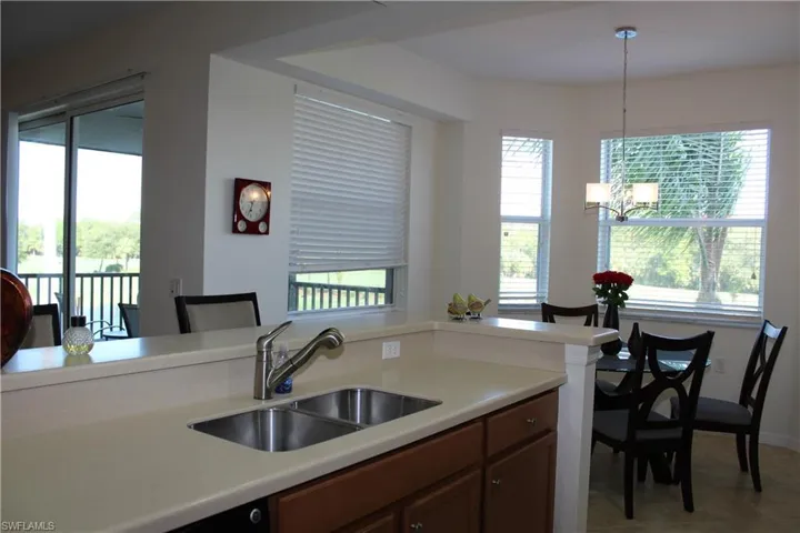 Kitchen featuring hanging light fixtures, a chandelier, and brown cabinetry