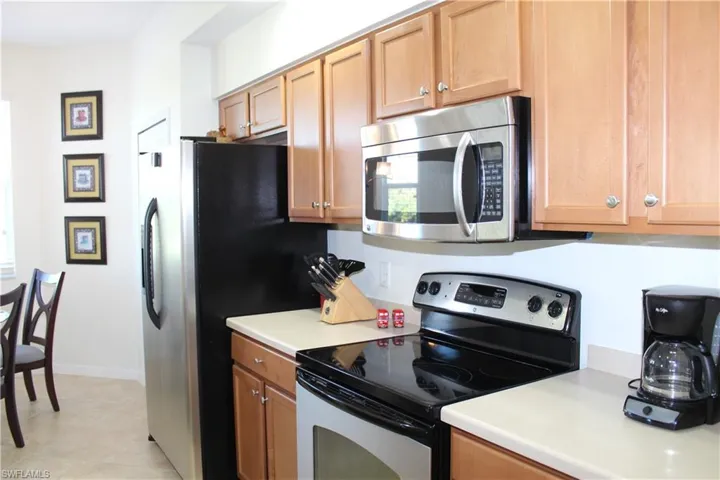 Kitchen featuring stainless steel appliances, light countertops, and light tile patterned floors