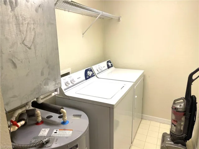 Laundry room with washer and dryer, water heater