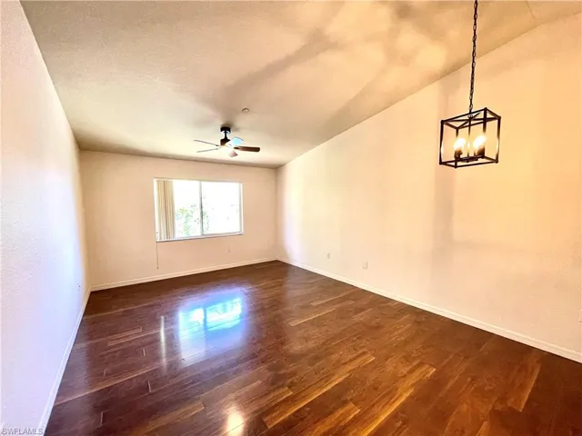 Livingroom featuring dark wood like floors, and new ceiling fan