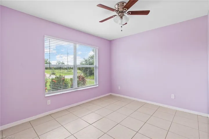 Spare room featuring ceiling fan and baseboards