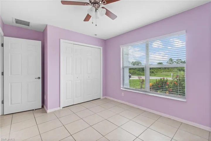 Unfurnished bedroom featuring a closet, ceiling fan, and light tile patterned floors