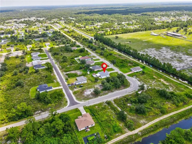 Aerial perspective of suburban area featuring a large body of water